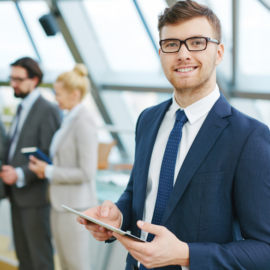 Professional man in office, holding tablet
