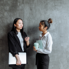 Professional women in conversation, in office