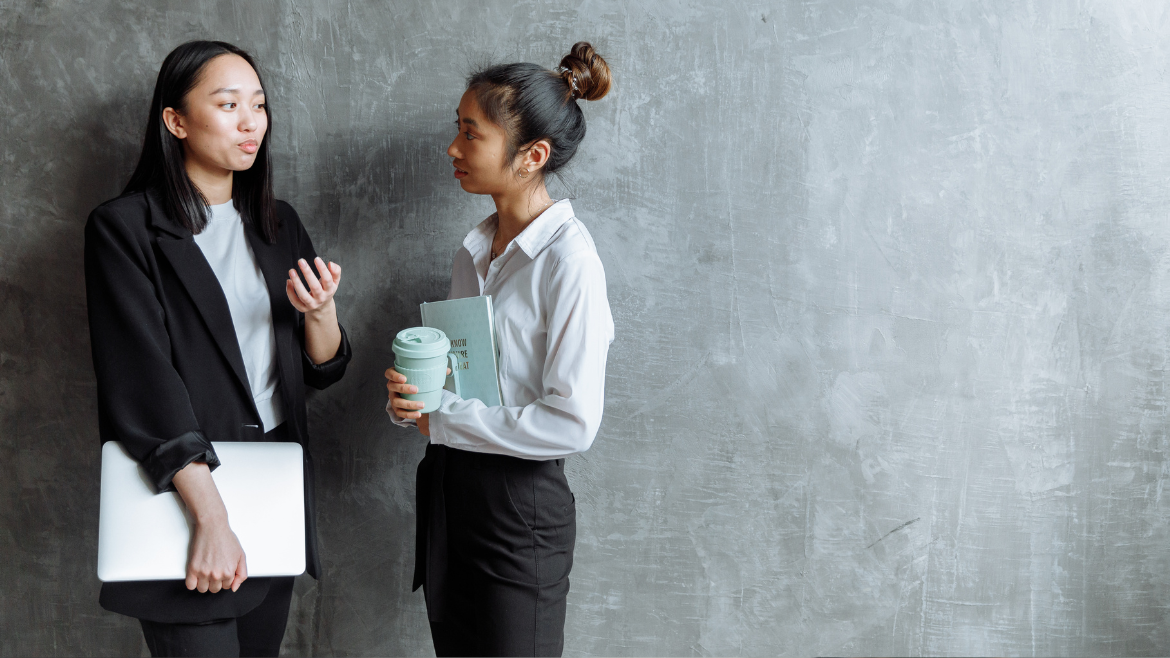 Professional women in conversation, in office