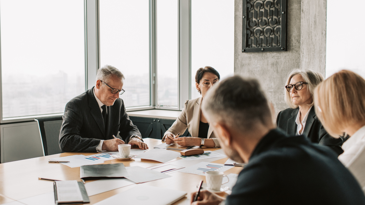 group of executives sitting at a conference table