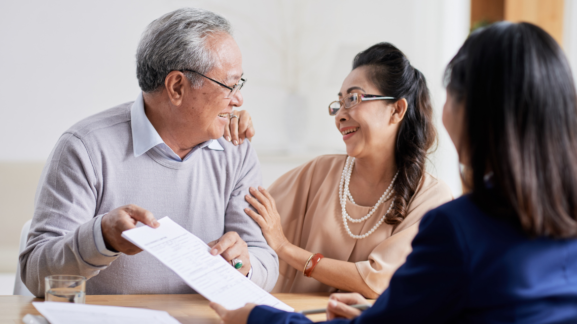 An older couple meeting with an advisor for estate planning